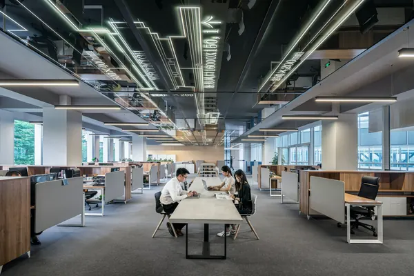 3 coworkers working together at the office- important differences of managed it services and staff augmentation