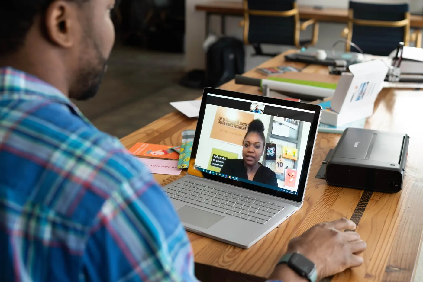 Two people meeting through zoom for work